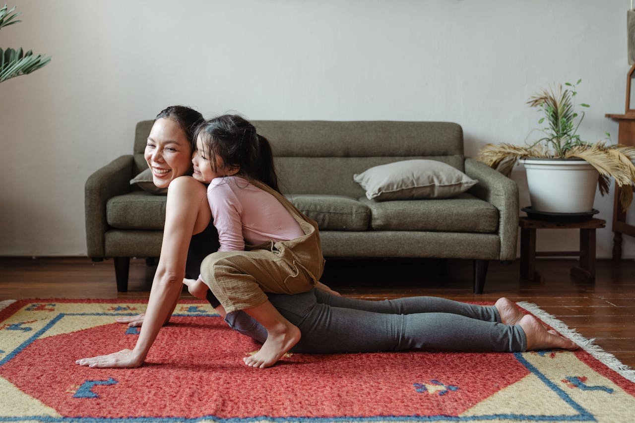 The Art of Drawing Readers In: Your attractive post title goes here A joyful mother practicing yoga with her daughter on a colorful rug indoors.
